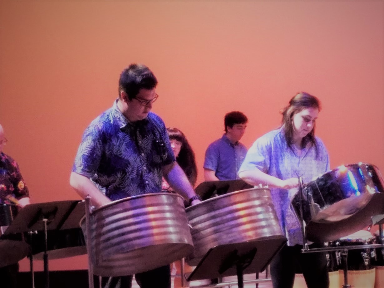 a band of steel pan drummers performs